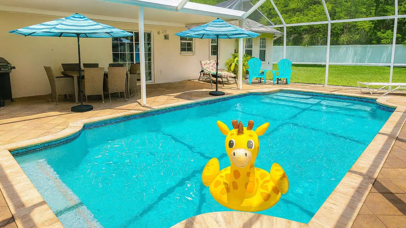 Screened pool with striped umbrellas, sun loungers and a grill at the pool home at 3105 40th Ave W in Bradenton